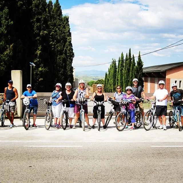 a group of people riding bikes down a street