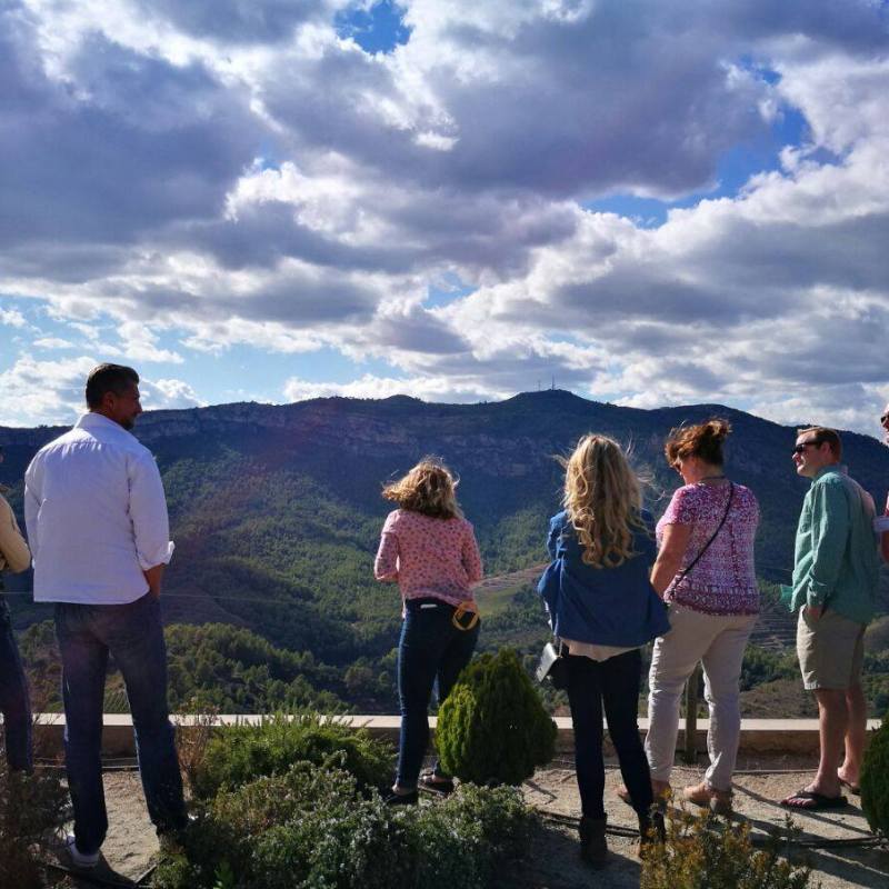 a group of people standing in front of a cloudy sky