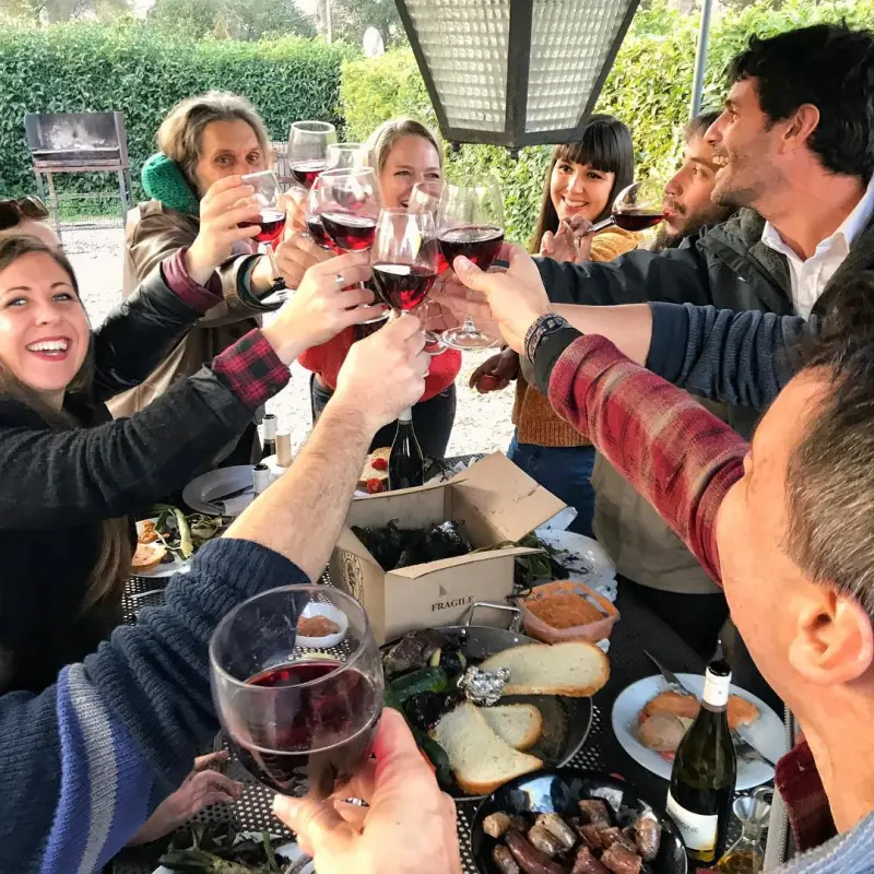 a group of people are drinking from a cup