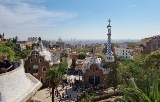 a large clock tower towering over Park Güell