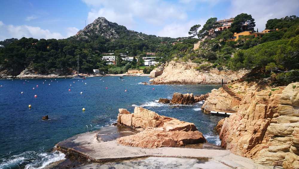 a rocky island in the middle of a body of water