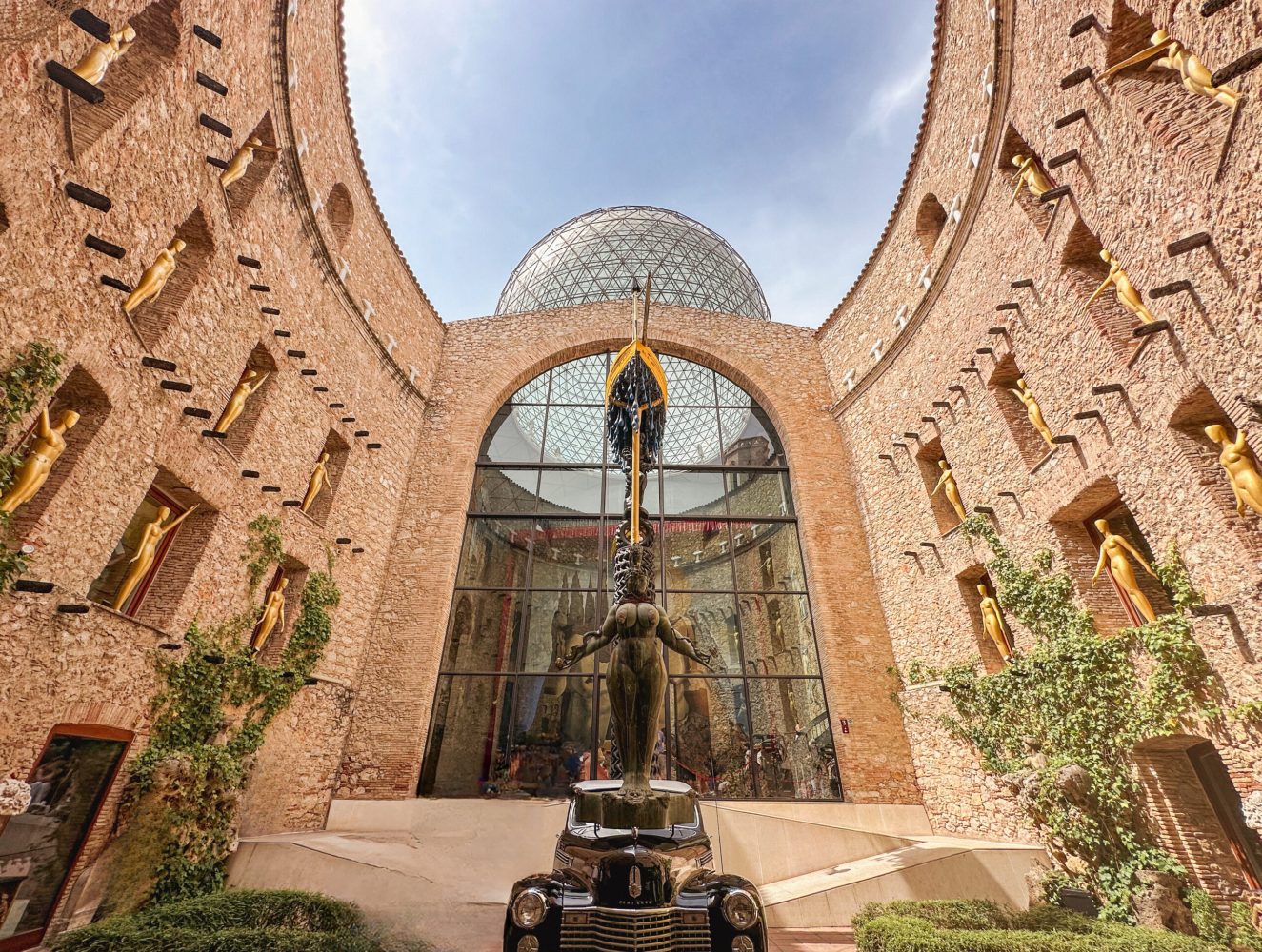 A statue in front of the Dalí museum building