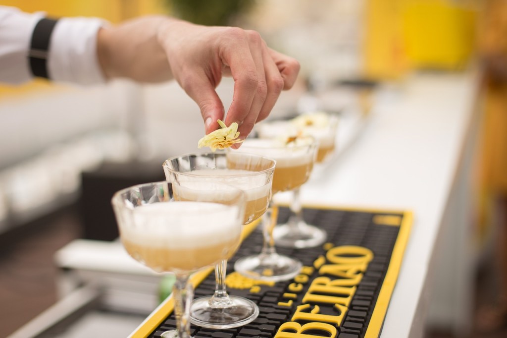 a person preparing a cocktail on the bar