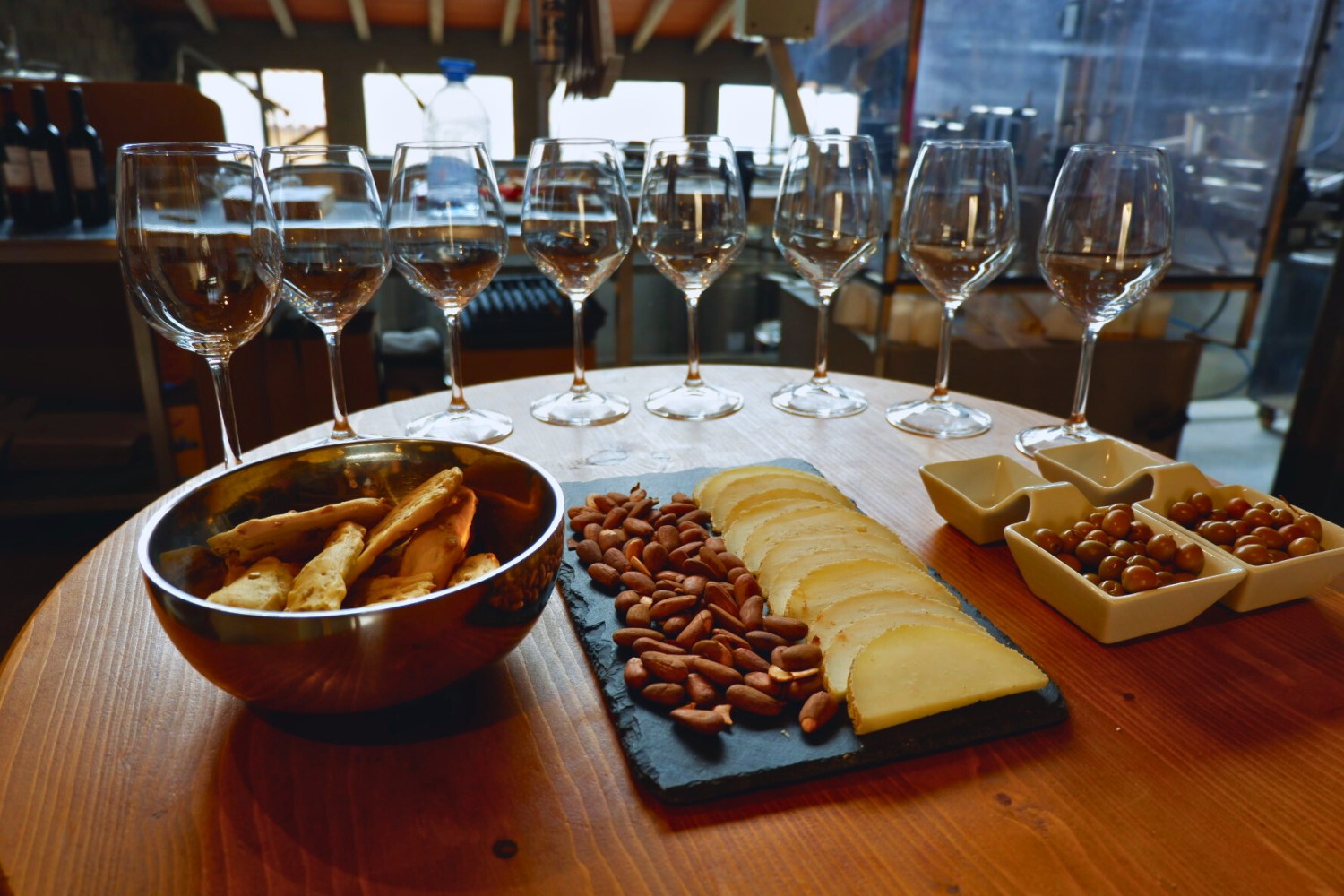 a glass of wine sitting on top of a wooden table