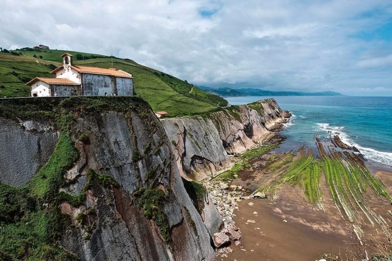 a rocky island in the middle of a body of water