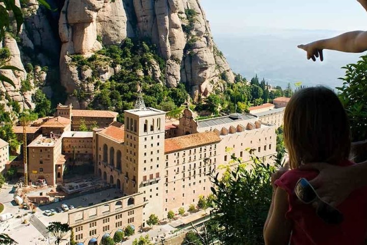 a person looking over a structure near a mountain