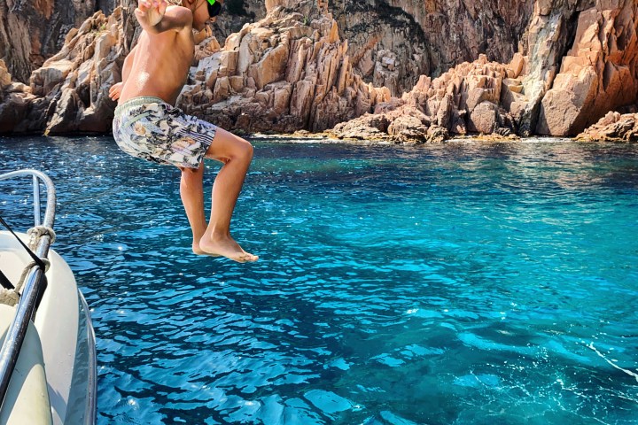a person sitting on a rock in a pool of water