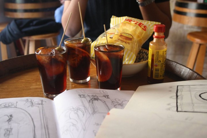 a cup of coffee sitting on top of a wooden table